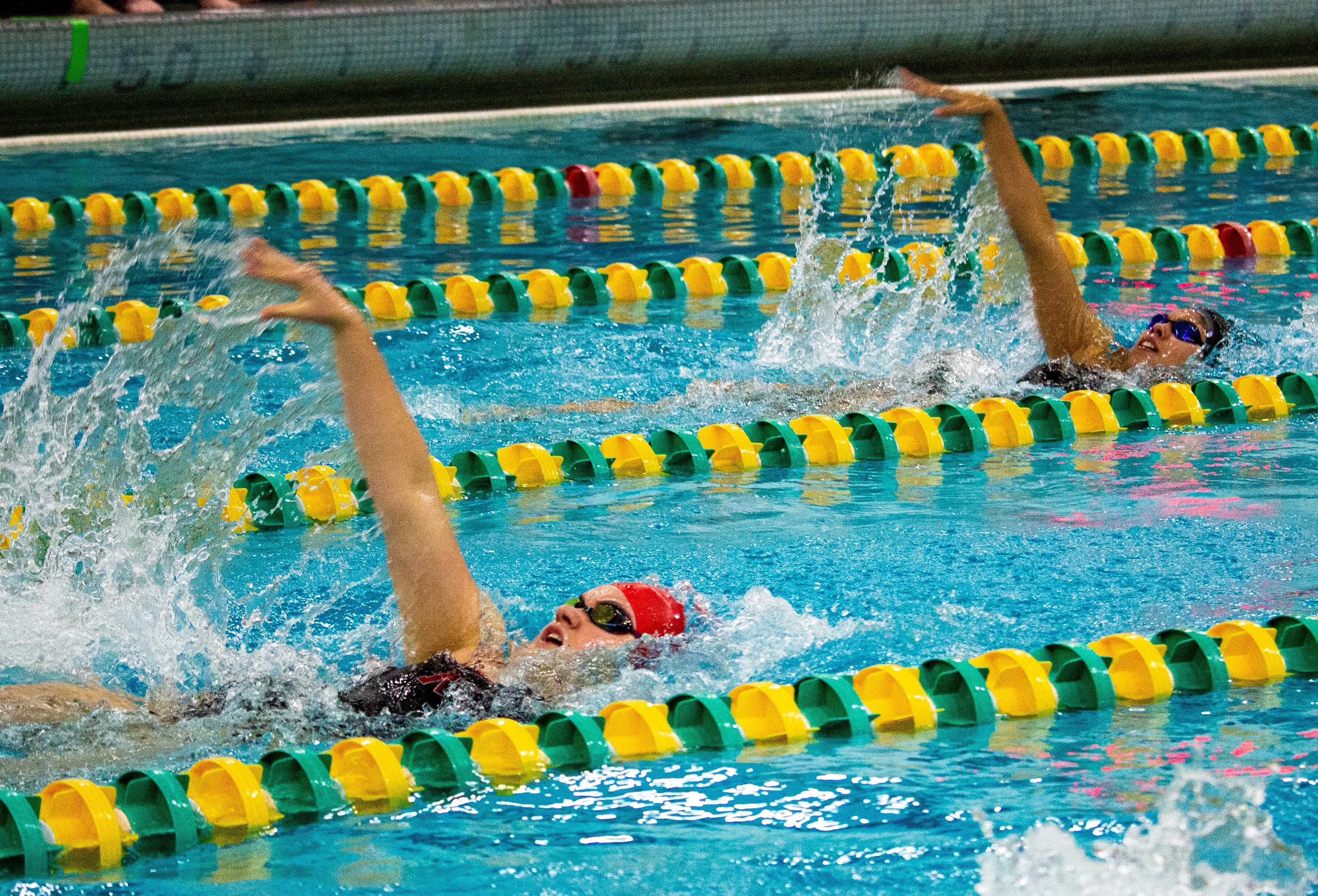 Two swimmers swimming backstroke